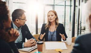 Office, meeting and business people with documents in discussion for negotiation, proposal and planning Employee, communication and idea in consultation for b2b merger, acquisition and consolidation